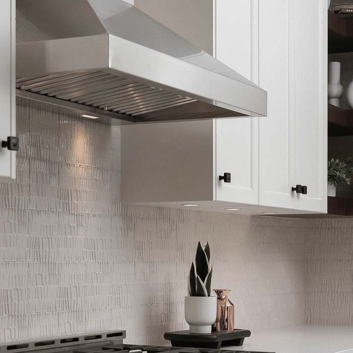 Modern stainless steel wall-mount quiet range hoods with high-efficiency baffle filters installed in a contemporary white kitchen