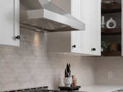 Victory Twister wall mount range hood installed in a modern kitchen with white cabinets and professional LED lighting