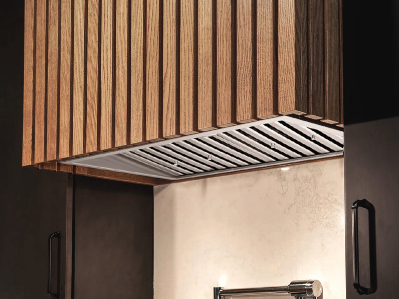 Victory Q2 range hood insert installed in modern wood-slat kitchen cabinet.