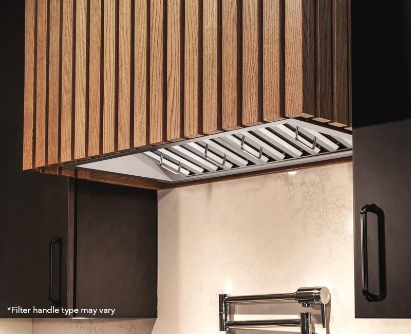 The Victory Q2 42-inch range hood insert installed inside a modern custom wood slatted kitchen hood