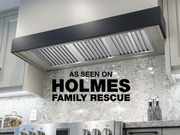 30 Inch 750 CFM Range Hood Insert installed in custom dark wood kitchen cabinetry with Holmes Family Rescue feature badge