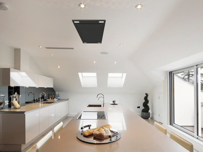 Matte Black Victory Sunset ceiling mount range hood installed in a modern white kitchen island ceiling for an open-concept view