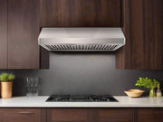 Modern kitchen installation showing the Cabinet Range Hood - VICTORY Verona mounted under dark wood cabinetry, providing high-capacity ventilation and a sleek, integrated look