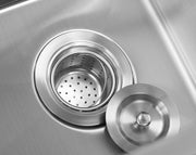 Top-down view of a stainless steel sink protector grid with a central drain cutout. 