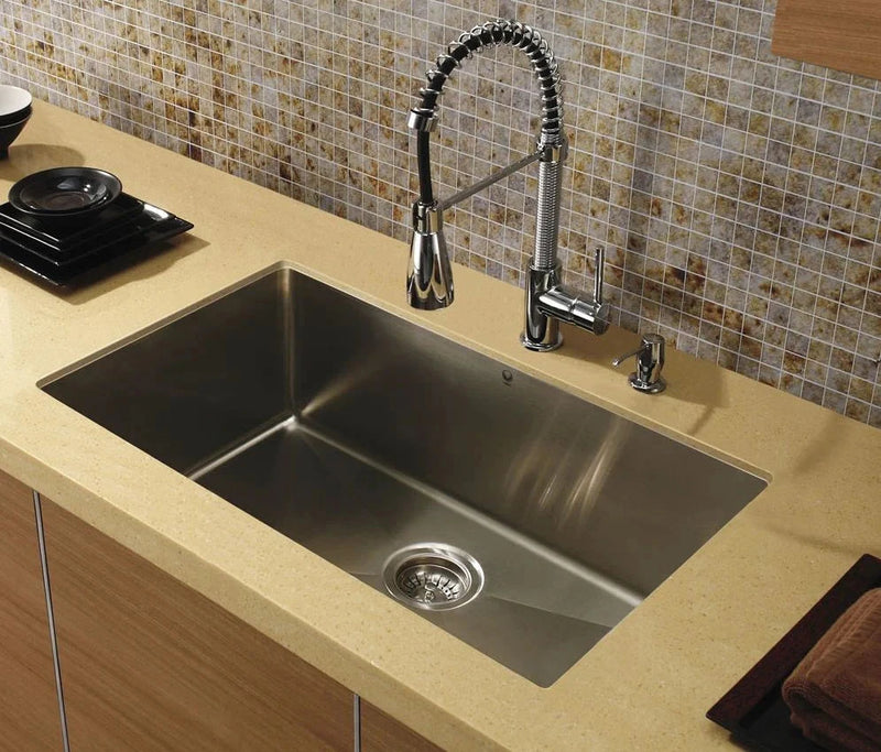 A rectangular stainless steel undermount sink basin showing the brushed metal finish and interior drainage slopes. 